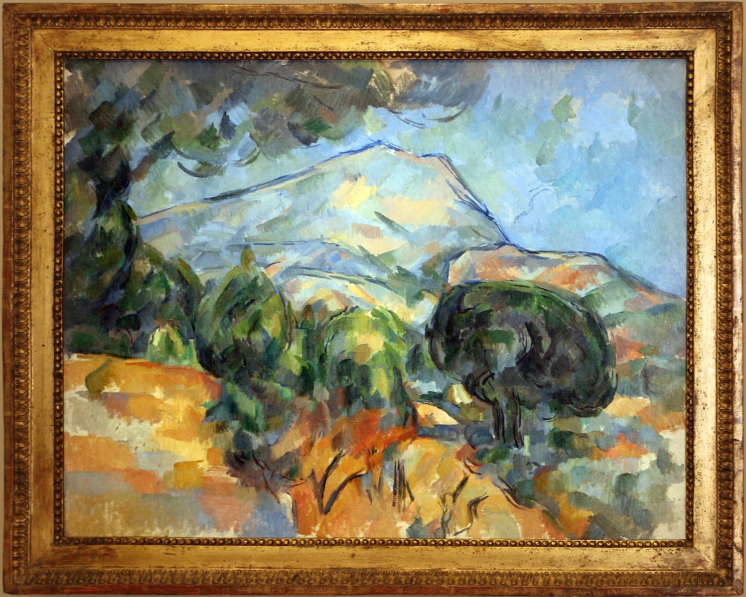A Montanha Sainte-Victoire acima da estrada do Tholonet (com pinheiro manso) - Paul Cézanne