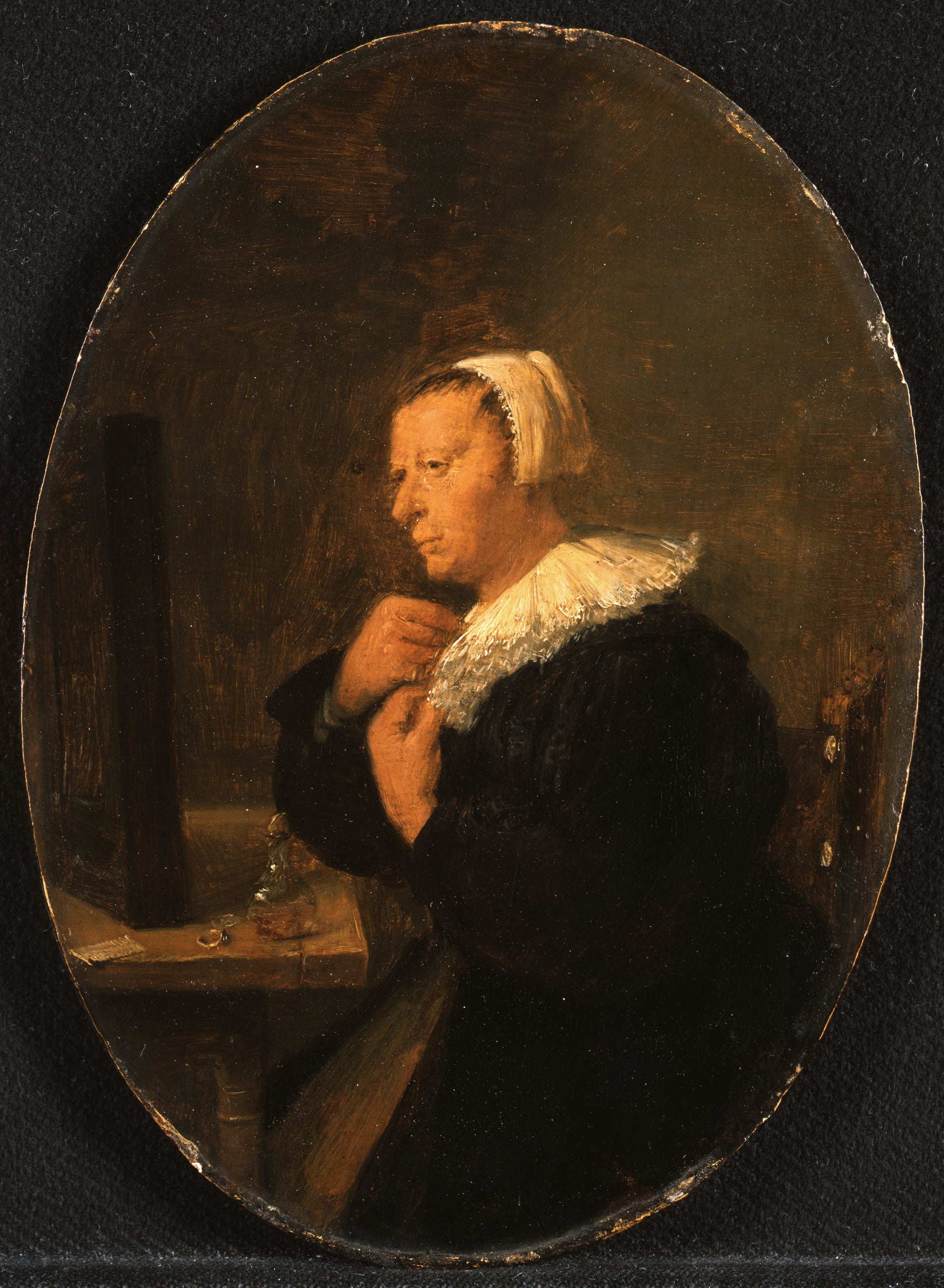 Femme assise à une table devant un miroir (se préparant) - Adriaen Brouwer